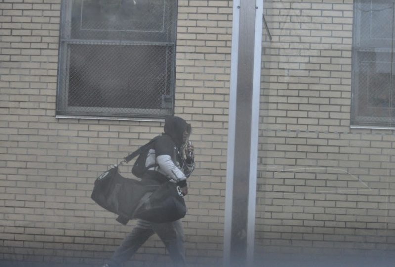 A surveillance photo of Michael Bassier carrying a duffel bag allegedly full of illegal guns. (Courtesy of the Brooklyn District Attorney's Office)