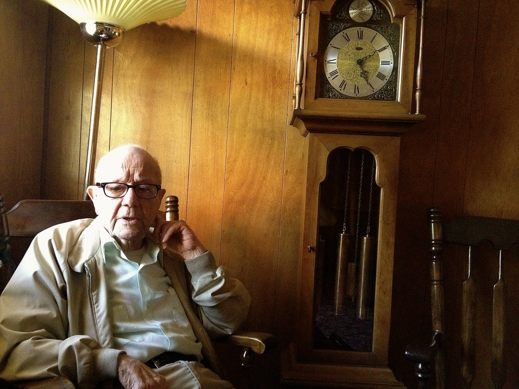Hughie Reid sitting in the front room of his funeral parlor (Photo: Aleksandra Mencel/NY City Lens).