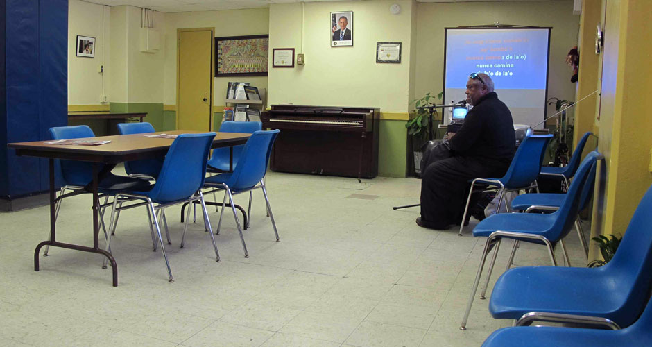 Marble Hill Senior Center member Crispin Lebron runs his karaoke machine to a near-empty room on Jan. 24, 2014. Attendance at the center was down sharply after the latest winter storm. (Steven Rosenbaum/NY City Lens)