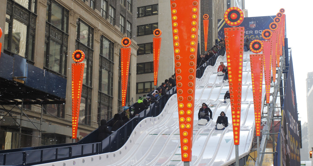 A 60-foot tall, 180-foot long toboggan stands on in Times Square. Broadway between 34th and 47th Streets has been transformed into Super Bowl Boulevard for four days, leading up to the big game.