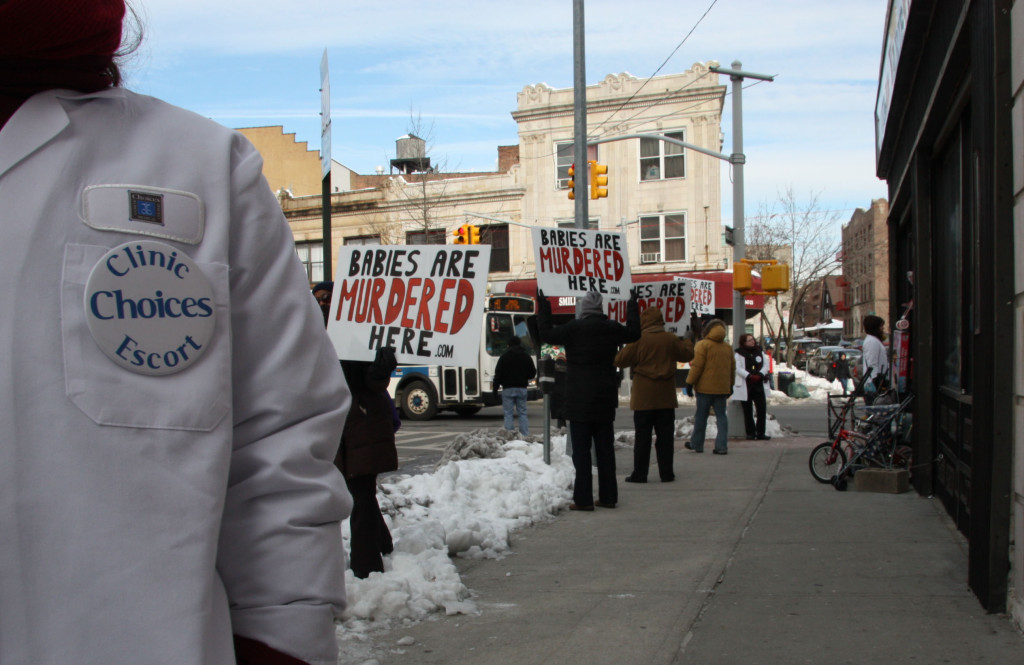 Clinic Escorts and anti-abortion protesters near Choices Women's Medical Center, in Jamaica, Queens. Credits: Sybile Penhirin