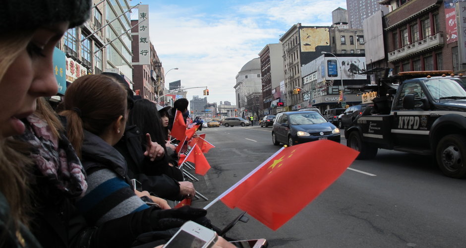 People wait for the annual Lunar New Year parade to begin at Manhattan Chinatown. (Younjoo Sang/NYCityLens)