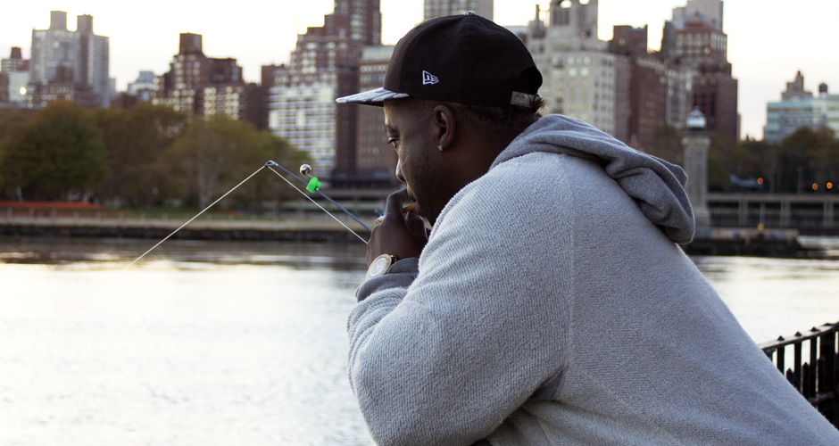 Shaun McCleese fishes in the East River, just south of the Astoria Houses campus at sunset on Monday, October 27, 2014. McCleese is a resident of the Astoria Houses. Photo by Elah Feder for NY City Lens.