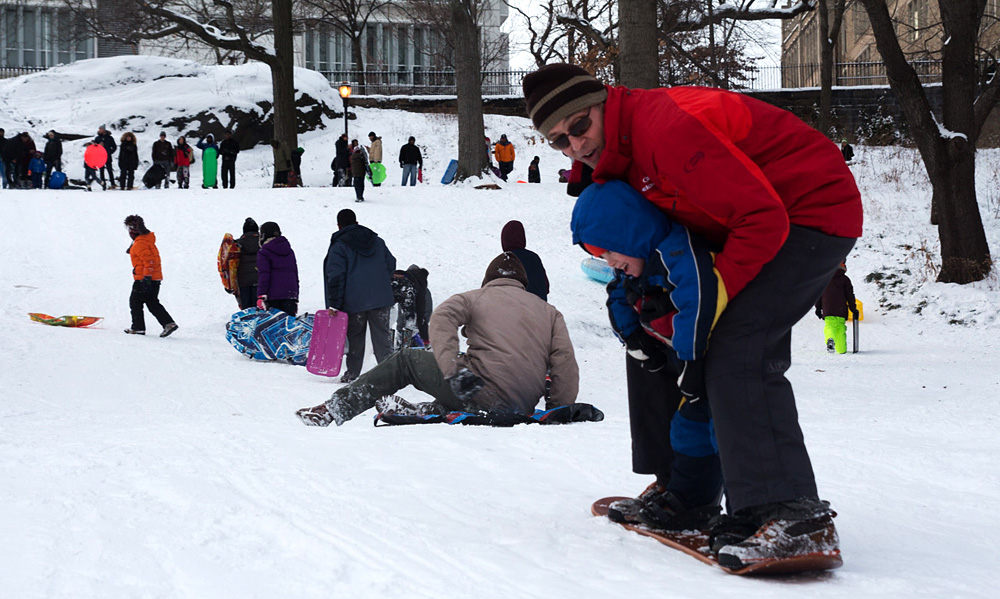 Patrick Mouton teaches his 5-year-old son Noah how to snowboard.
