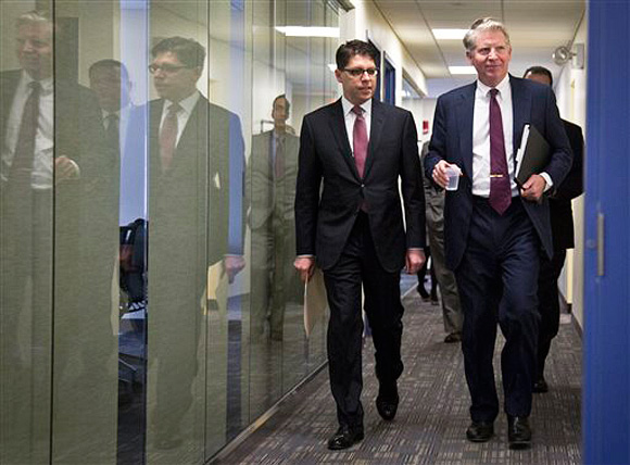 Manhattan District Attorney Cyrus Vance, right, and Department of Investigation Commissioner Mark Peters arrive for a press conference to announce the indictment of 50 defendants involved in widespread housing fraud, Tuesday, Feb. 10, 2015, in New York. Authorities say 16 city inspectors and dozens of landlords and contractors formed a network that exchanged $450,000 in payoffs to get safety violations dismissed and procure phony orders to toss out tenants. (AP Photo/Bebeto Matthews)