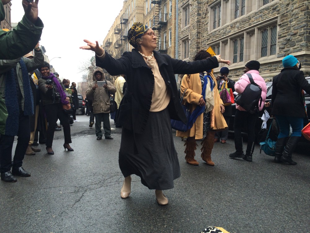 A woman dances in the street.