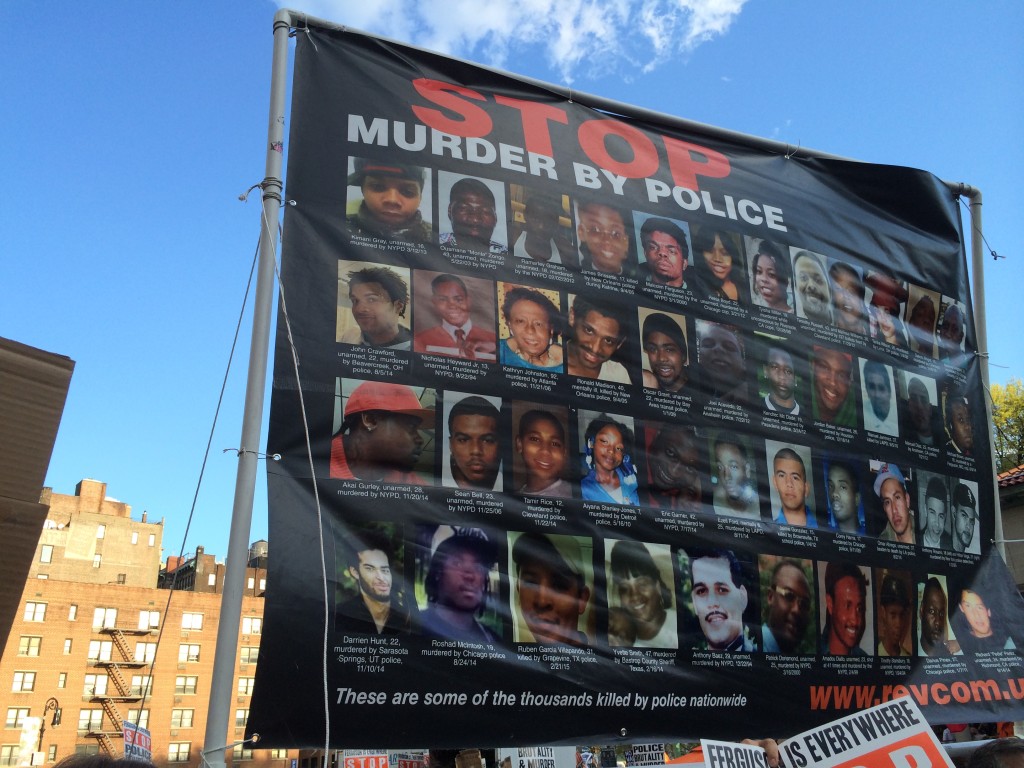 A banner with pictures of young black men killed by police. 