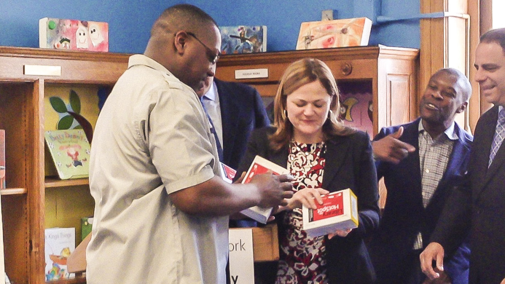 City Council Speaker Melissa-Mark Veverito hands out free Sprint mobile hot spot devices to a Bronx resident at Mott Haven Library. 