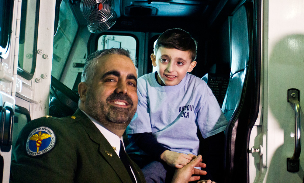 Deputy Chief Anthony Ardolino and his son Anthony Luca celebrate the Department of Sanitation's first World Autism Day. (Cara McGoogan/NY City Lens)