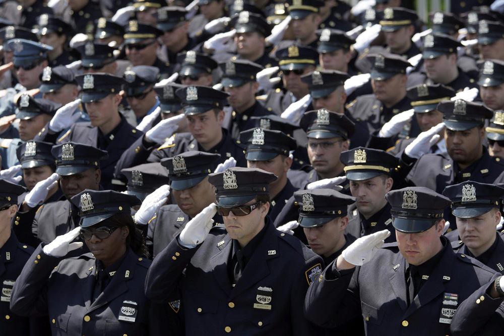 Officers Give the Salute for Officer Moore. (Mary Altaffer/AP Photo)