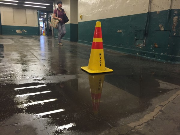 A puddle of water falls from a cracked ceiling and collects on the Kings Highway train station in Brooklyn, NY. Photo: Sneha Antony.