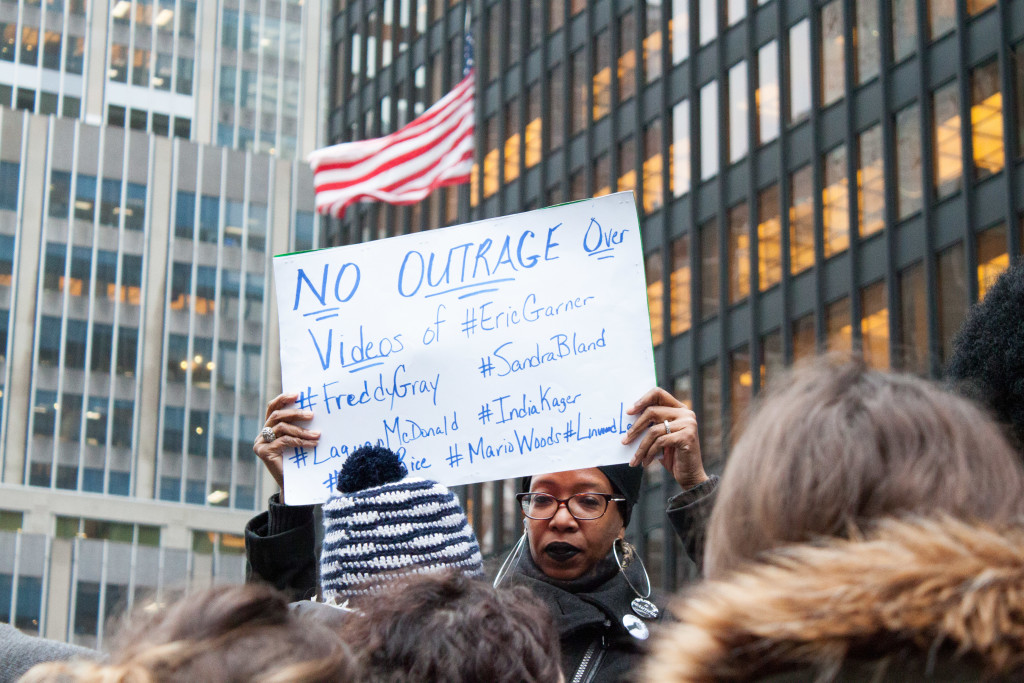 A pro-Beyonce protester held a sign saying, "No Outrage Over Videos of #EricGarner #FreddyGrey #SandraBland." Photo by Ang Li