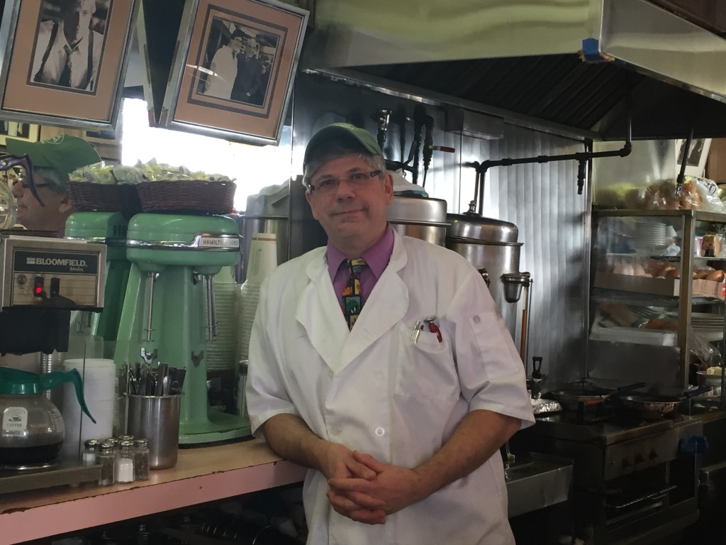 Owner John Philis leans against the Hamilton Beach milkshake mixer that dates back to 1940. (Mary Kekatos)