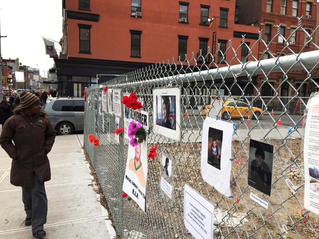 Residents and passerby were reminded of Nicholas Figueroa and Moises Locon, both killed by the gas explosion that ripped through an East Village apartment building last March. (David Roza)