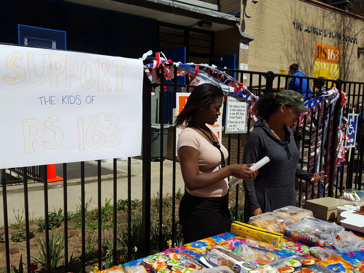 Kadidja Rea (left), a parent volunteer, and Nicki Reidy (right), a PTA member, run a bake sale outside PS 163, a polling station during the New York Primary.