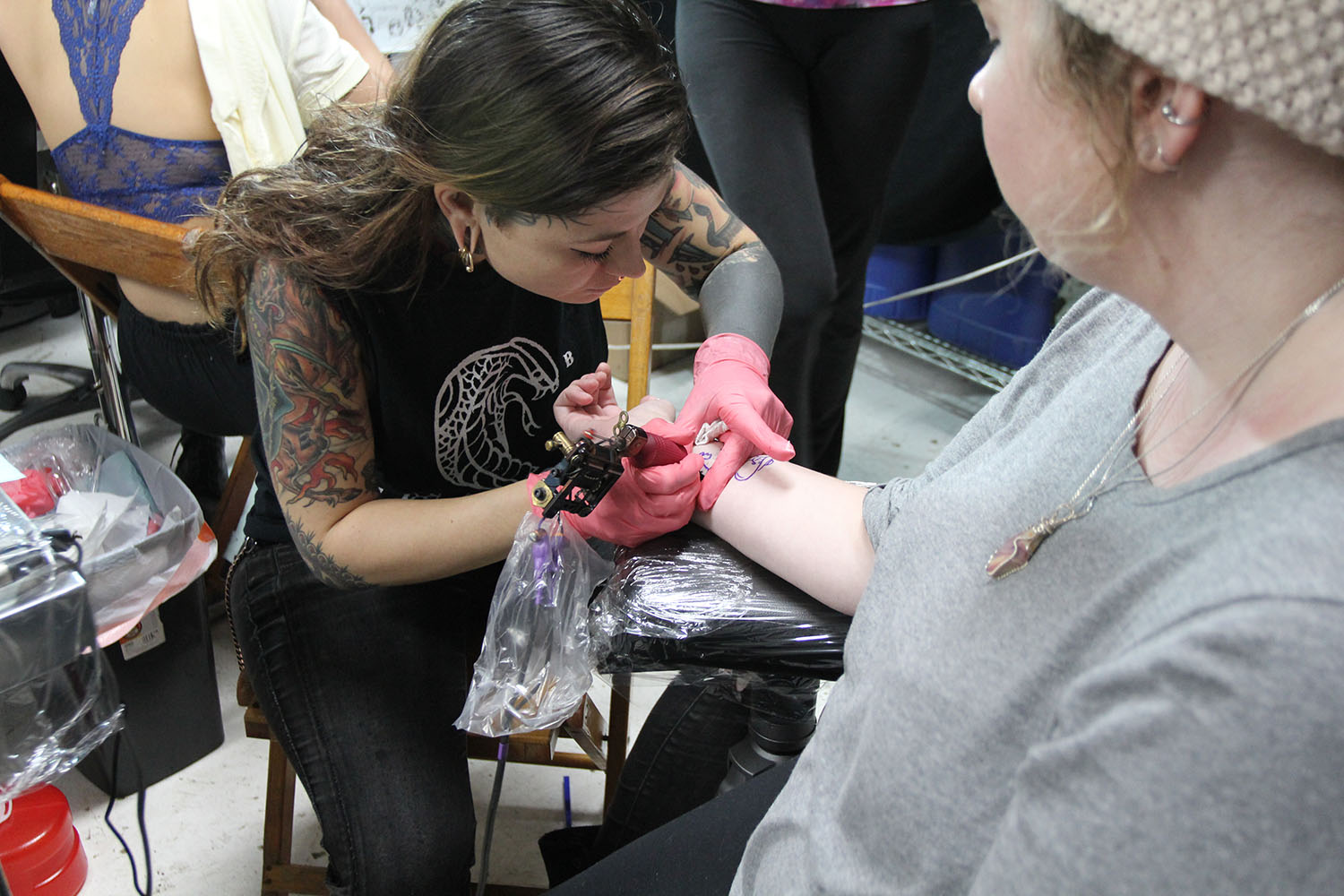 Katie Adams receiving her first tattoo (Quincey Trigillo / NY City Lens)
