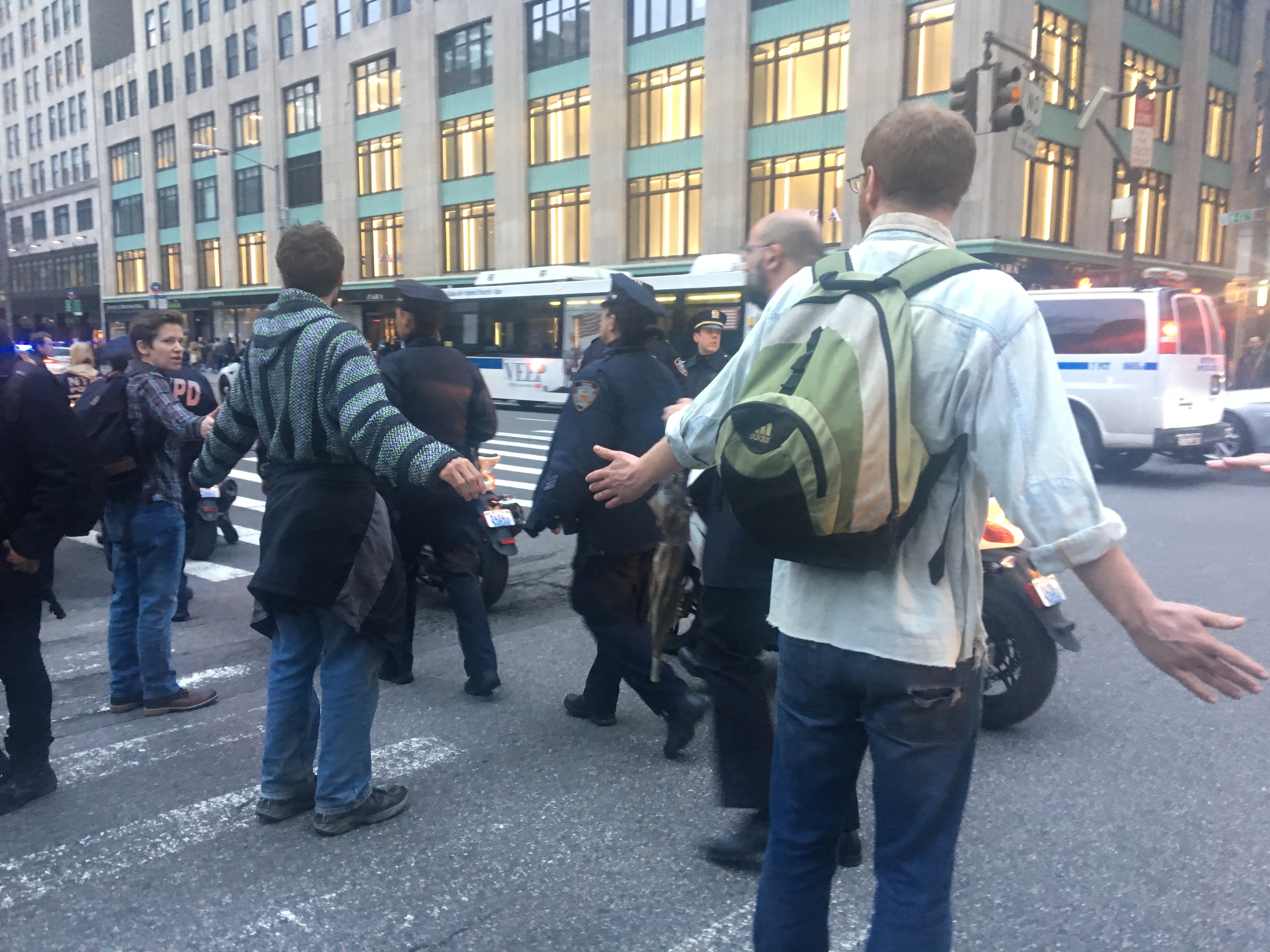 Protesters block police from the sidewalk.