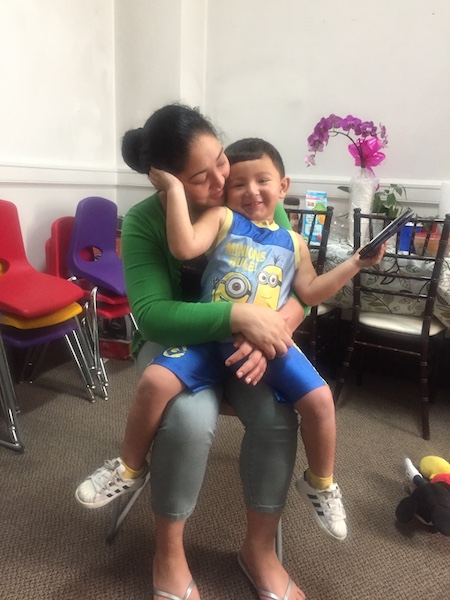 Amanda Morales Guerra holds her son David, 2, at Holyrood Episcopal Church on Tuesday, Sept. 12