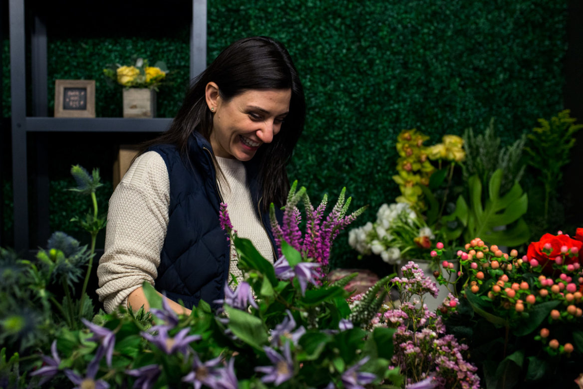 Alex Avdoulos stores bouquets in a refrigerator until they can be delivered. (Angie Wang for NY City Lens)