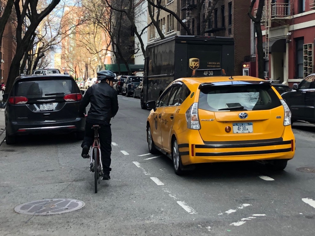 Double-parked delivery truck forces Taxi into bike lane