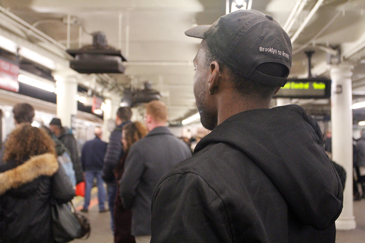 Derrick Richard waiting to catch the shuttle train at Times Square (Monique LeBrun/ NY City Lens)