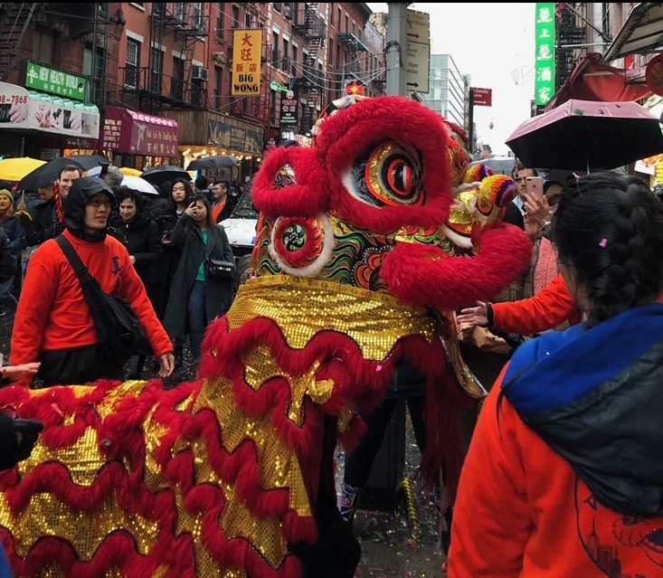 A Chinese lion parades through Chinatown during New Year.