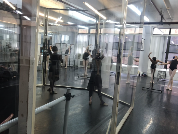 Ballet instructor Elena Madrigal teaches while separated from students by plexiglass.