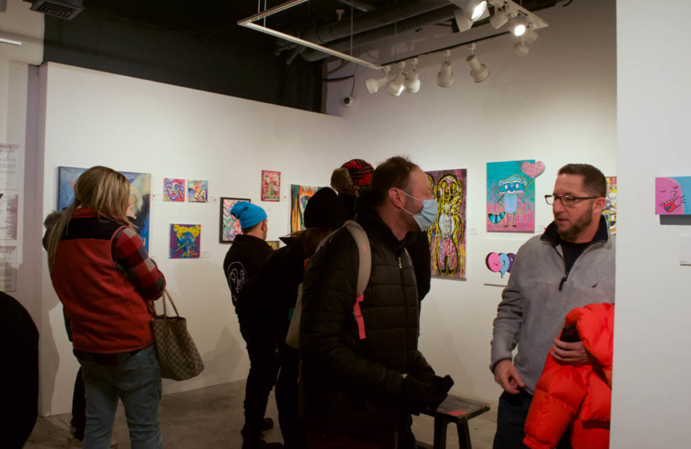 Visitors at the opening of the "New York Artists for the Bronx" exhibit at the West Chelsea Contemporary gallery had the chance to speak directly with exhibiting artists about their art pieces on Saturday, January 29. Elizabeth Maline for NY City Lens
