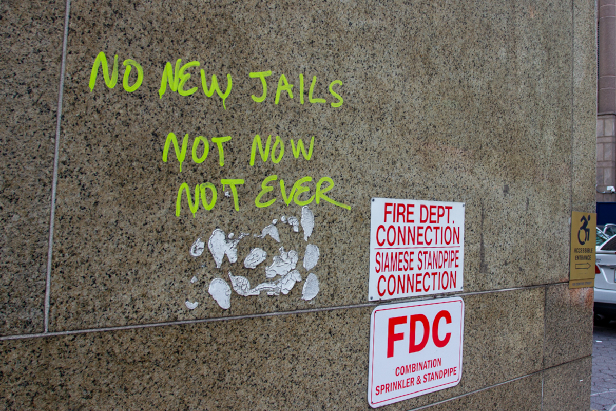 Anti-jail graffiti on the South Tower of the Manhattan Detention Complex on Wednesday February 23, 2022. Credit: Elizabeth Maline for NY City Lens.