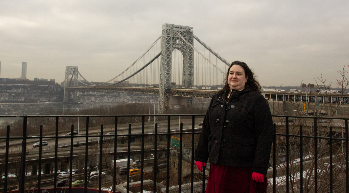 Woman in front of the George Washington Bridge. 
