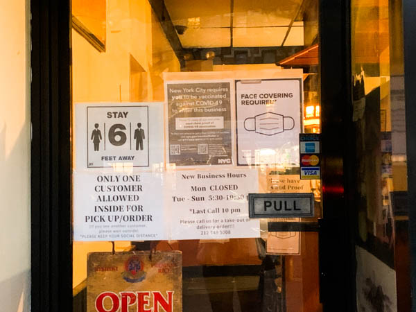 Japanese restaurant Yakitori Sun-Chan has both vaccine and mask mandate posters on their door. Wednesday, Feb.9, 2022 (Photo Credits: Soo Min Kim for NY City Lens)