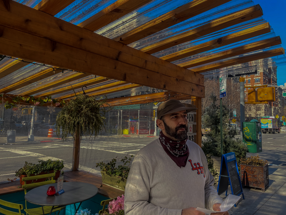 Brian Felicetta stands beside a shed at his Morningside Heights, Manhattan, bar on Tuesday, Feb. 9, 2022. The Department of Transportation said on Tuesday it does not envision sheds in outdoor dining's post-Covid future. Credit: Luke Cregan for NY City Lens.