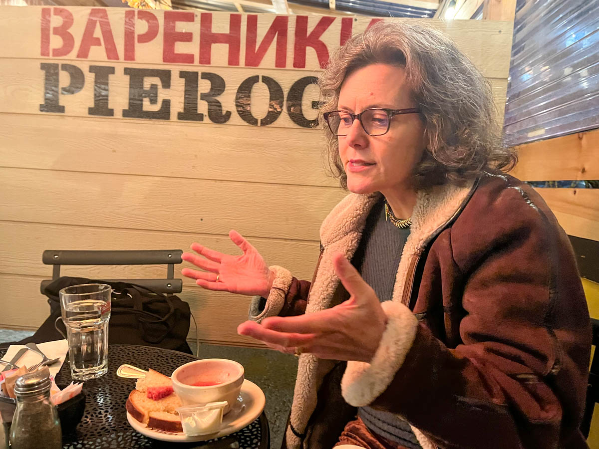 Dora Chomiak, President of Razom. She sits with a bowl of borscht, a traditional Ukrainian soup, at Veselka, a Ukrainian restaurant in Manhattan's Little Ukraine. Credit: Niamh Rowe for NY City Lens.