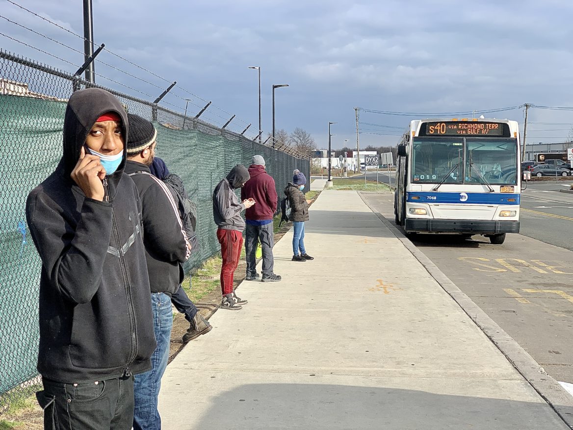 Amazon Warehouse employees are lining up at the bus stop to get back home after the vote. March 25th, 2022. (Photo by Soo Min Kim for NY City Lens)