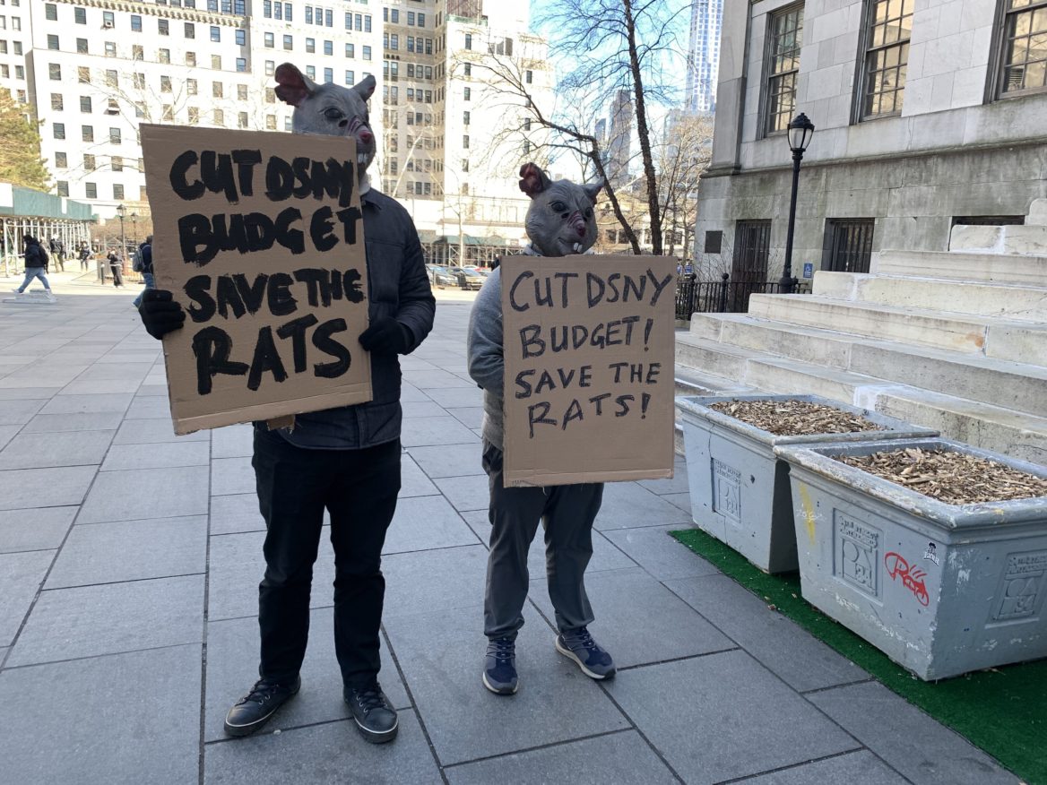 Two NYC residents ironize about the city’s issue with rats at the rally held in front of Brooklyn Borough Hall to get sanitation done. Mar 3, 2022. (Photo by Eleonora Francica for NY City Lens)