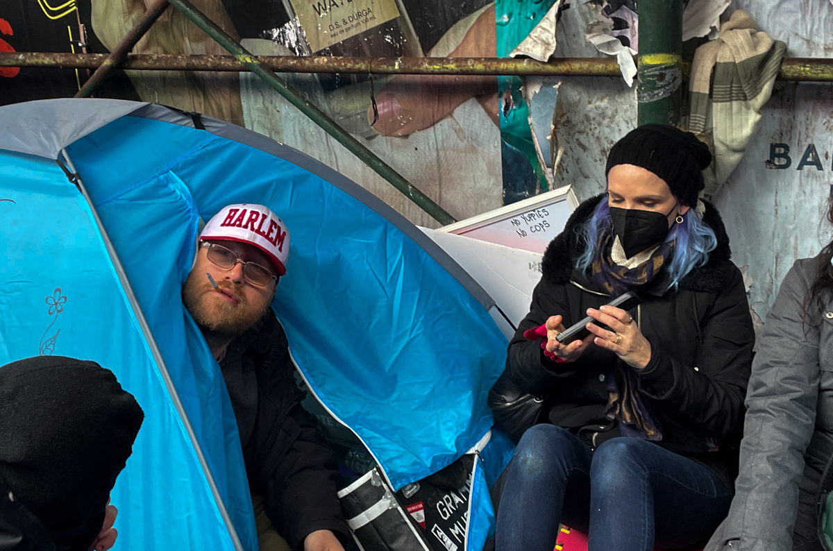 Johnny Grima and his activist ally Judith Haider among the tents of Anarchy Row on Wednesday, April 6, 2022. Credit: Luke Cregan for NY City Lens.